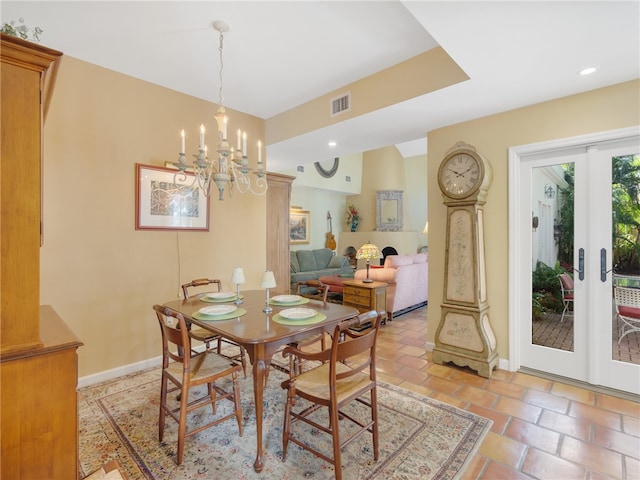 dining area featuring french doors and a notable chandelier