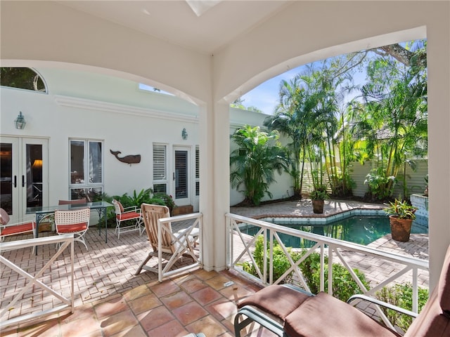 view of patio with french doors and a fenced in pool