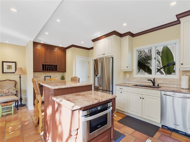 kitchen featuring backsplash, a center island, stainless steel appliances, and sink