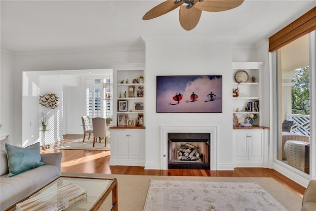 601 N Swim Club Dr Unit 3A, Vero Beach, FL 32963 - living room with wood finished floors, healthy amount of natural light, built in features, and crown molding