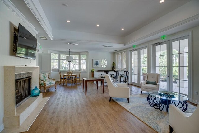 601 N Swim Club Dr Unit 3A, Vero Beach, FL 32963 - living room with a raised ceiling, french doors, a premium fireplace, light wood-style flooring, and recessed lighting