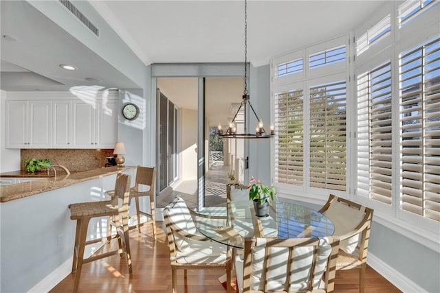 601 N Swim Club Dr Unit 3A, Vero Beach, FL 32963 - dining area featuring a chandelier and wood finished floors