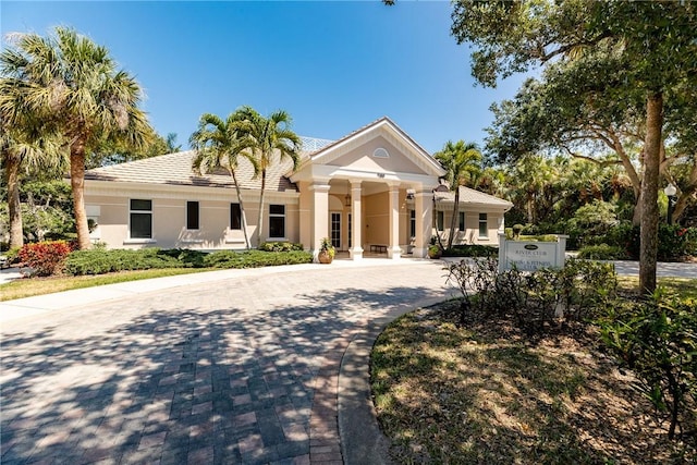 601 N Swim Club Dr Unit 3A, Vero Beach, FL 32963 - greek revival inspired property with stucco siding and curved driveway