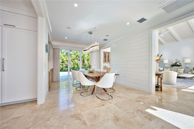 dining space featuring recessed lighting, visible vents, and wooden walls