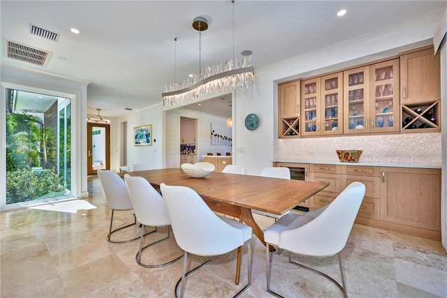 dining space with crown molding, recessed lighting, and visible vents