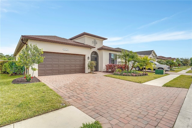 view of front of house featuring a garage and a front lawn