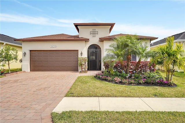 mediterranean / spanish-style house with a front lawn and a garage