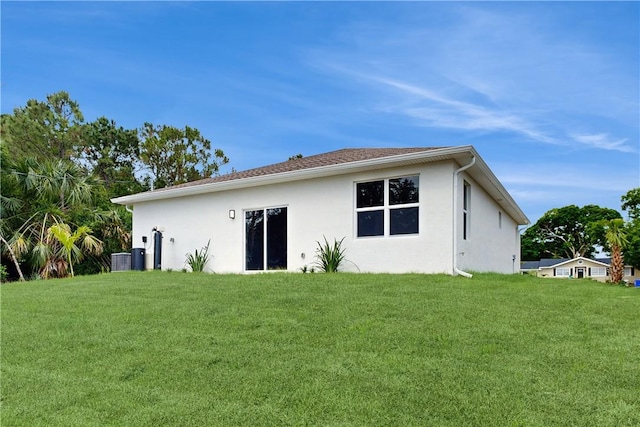 8050 97th Ct, Vero Beach, FL 32967 - rear view of house with stucco siding and a yard