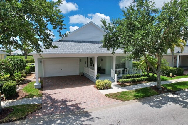 view of front facade with a garage and covered porch