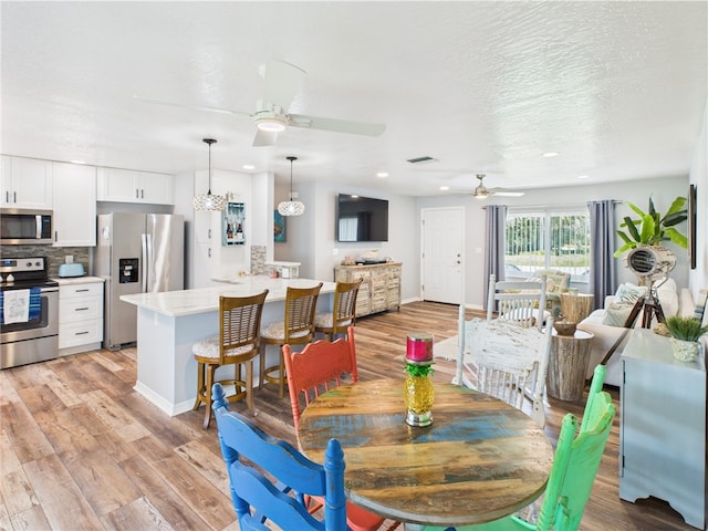 249 Columbus St, Sebastian, FL 32958 - dining space featuring a ceiling fan, light wood finished floors, recessed lighting, baseboards, and a textured ceiling