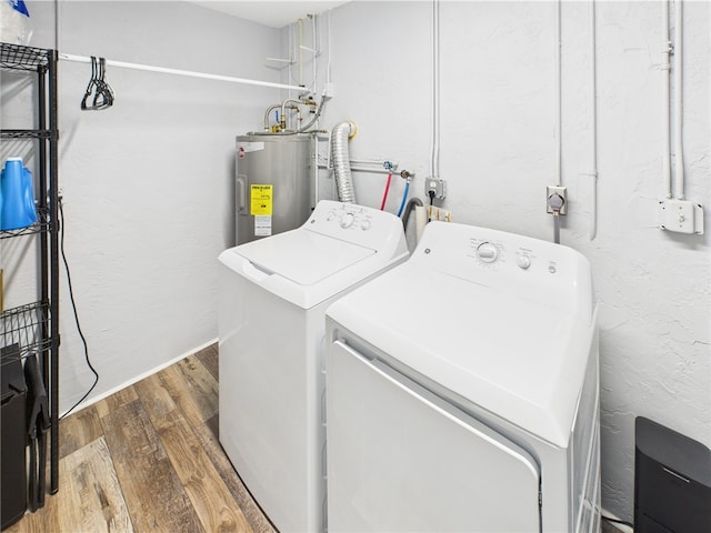249 Columbus St, Sebastian, FL 32958 - laundry area featuring water heater, washing machine and dryer, and wood finished floors