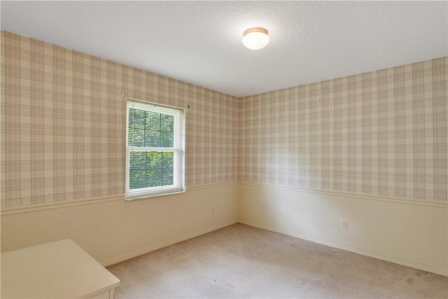 2615 15th St, Vero Beach, FL 32960 - empty room with wallpapered walls and carpet flooring