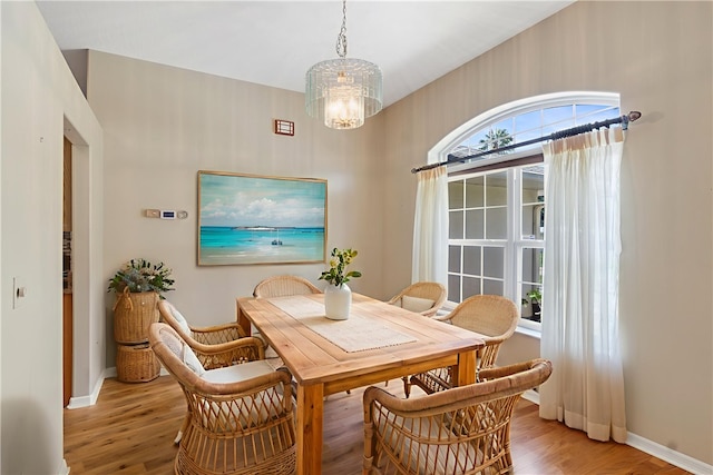 2615 15th St, Vero Beach, FL 32960 - dining area with light wood finished floors and a chandelier