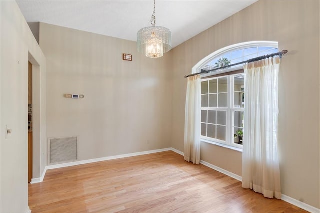 2615 15th St, Vero Beach, FL 32960 - spare room featuring light wood-style flooring and a chandelier