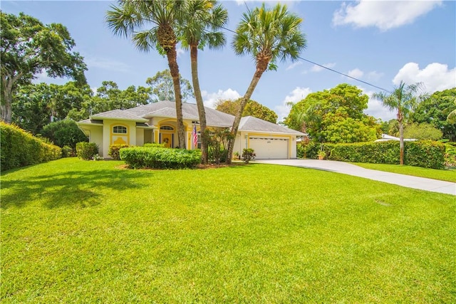 2615 15th St, Vero Beach, FL 32960 - view of front of property featuring concrete driveway, a garage, a front yard, and stucco siding