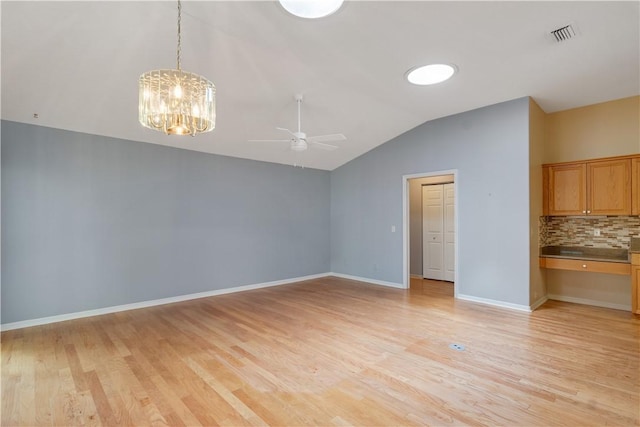 2615 15th St, Vero Beach, FL 32960 - unfurnished dining area with vaulted ceiling, a ceiling fan, a chandelier, and light wood-style flooring