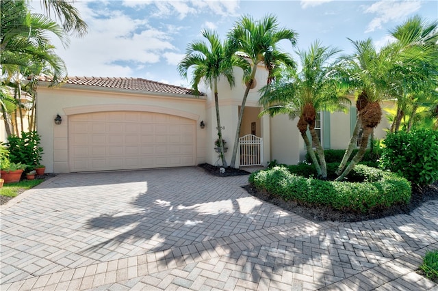 mediterranean / spanish-style home with a garage