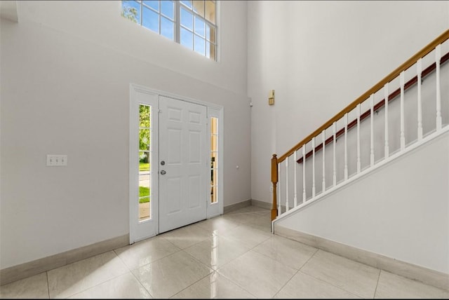 6057 Ridge Lake Cir, Vero Beach, FL 32967 - tiled foyer entrance with stairway and a towering ceiling