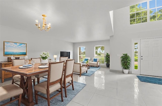 6057 Ridge Lake Cir, Vero Beach, FL 32967 - dining room featuring a chandelier, light tile patterned floors, and a high ceiling