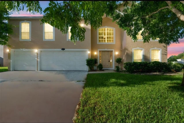 6057 Ridge Lake Cir, Vero Beach, FL 32967 - view of front facade with a garage, stucco siding, concrete driveway, and a lawn