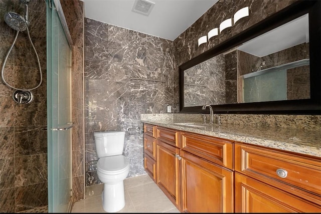 6057 Ridge Lake Cir, Vero Beach, FL 32967 - full bath featuring tile walls, vanity, a stall shower, and tile patterned floors