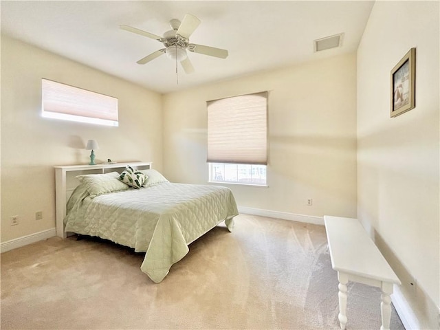 bedroom featuring light colored carpet and ceiling fan