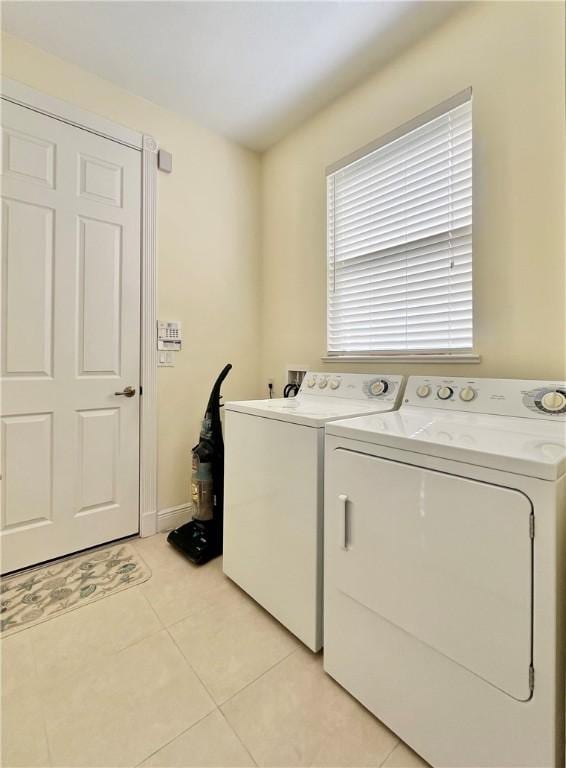 washroom featuring independent washer and dryer and light tile patterned flooring