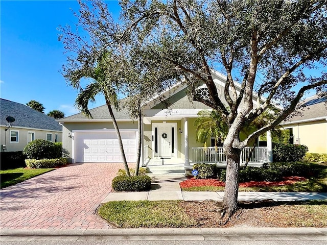 view of front of house featuring covered porch and a garage