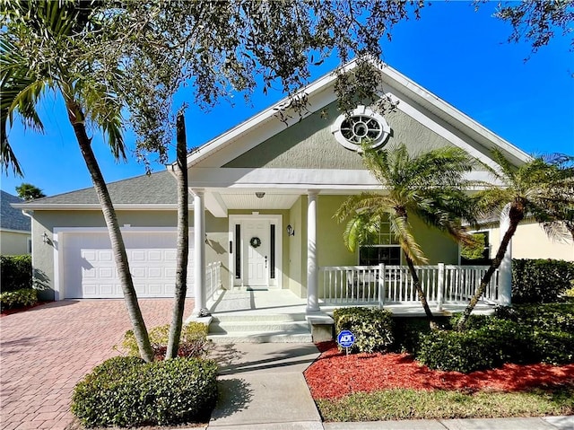 view of front of house with a porch and a garage