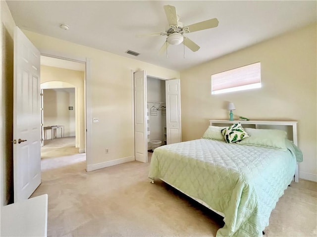 bedroom featuring ceiling fan, a closet, and light carpet