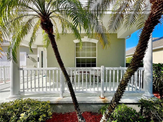 view of side of property with covered porch