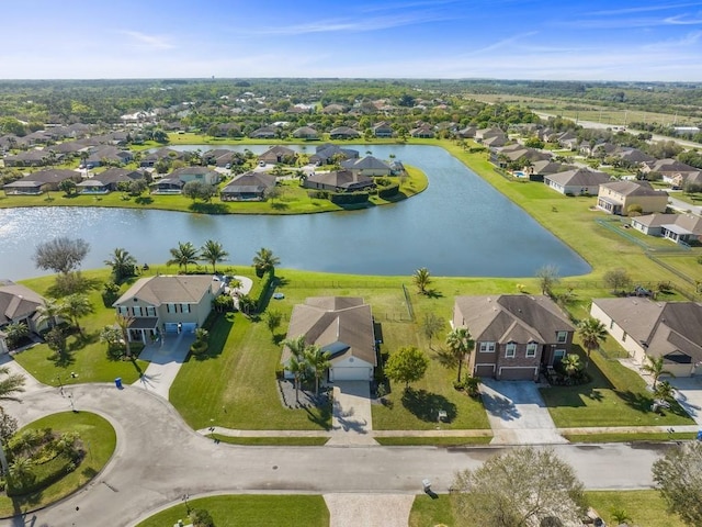 drone / aerial view featuring a residential view and a water view