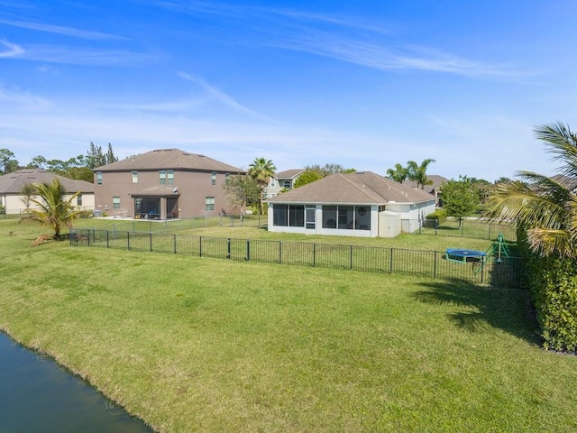 view of yard featuring a sunroom and fence