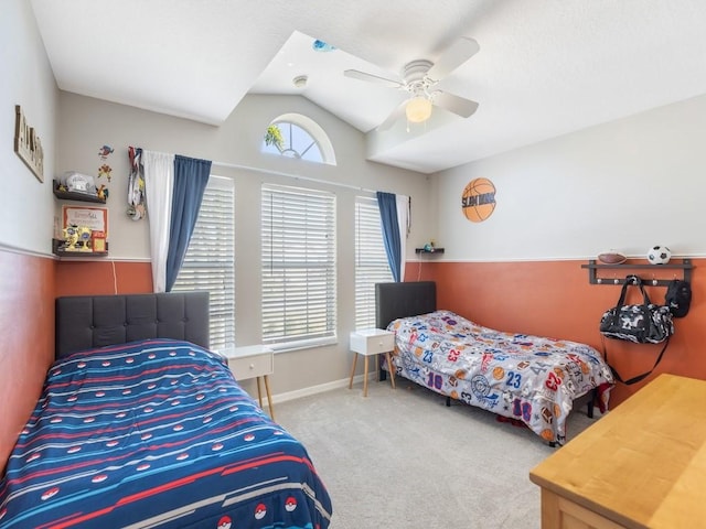 carpeted bedroom featuring lofted ceiling, a ceiling fan, and baseboards