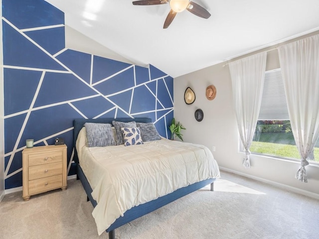 carpeted bedroom featuring lofted ceiling, a ceiling fan, and baseboards