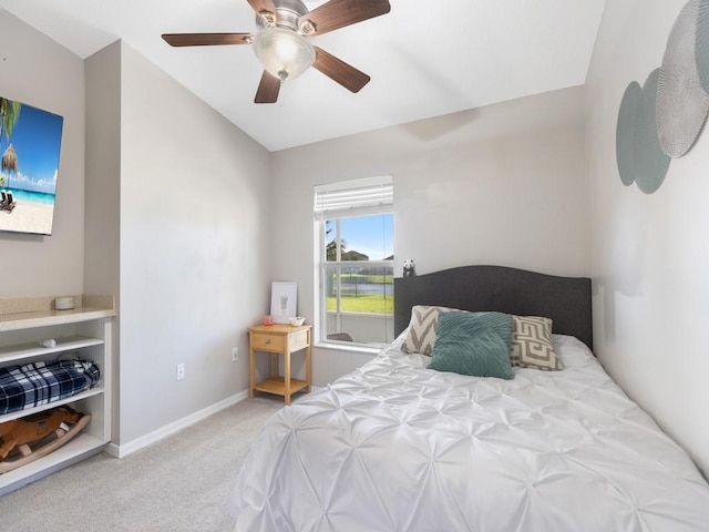 carpeted bedroom with baseboards and ceiling fan