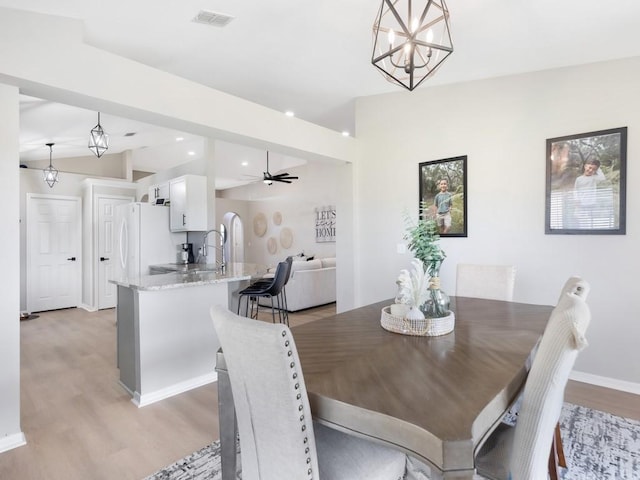 dining area featuring visible vents, ceiling fan with notable chandelier, recessed lighting, light wood finished floors, and baseboards