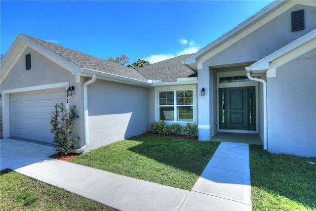 view of exterior entry featuring a garage, a shingled roof, and stucco siding