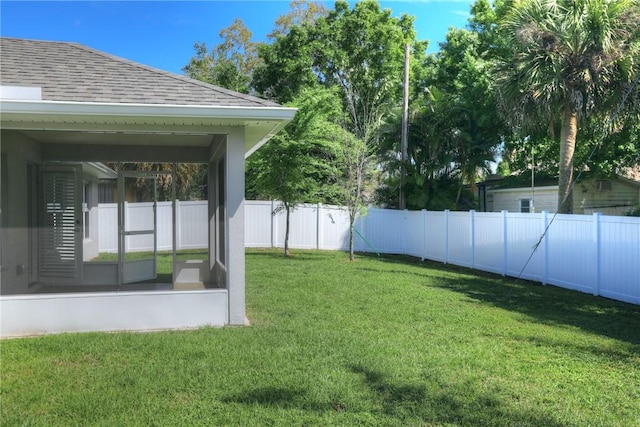 view of yard with a fenced backyard and a sunroom