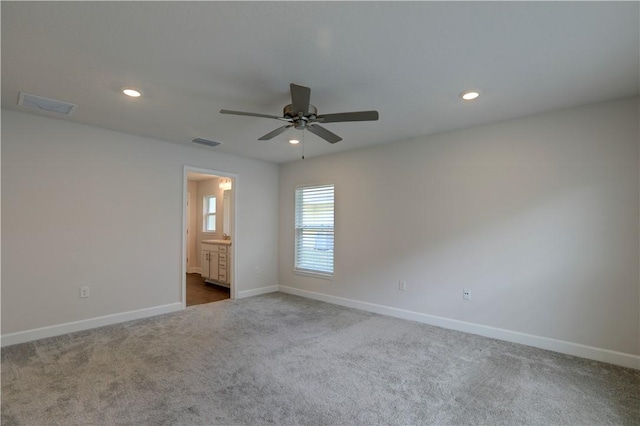 unfurnished bedroom featuring carpet, visible vents, and baseboards