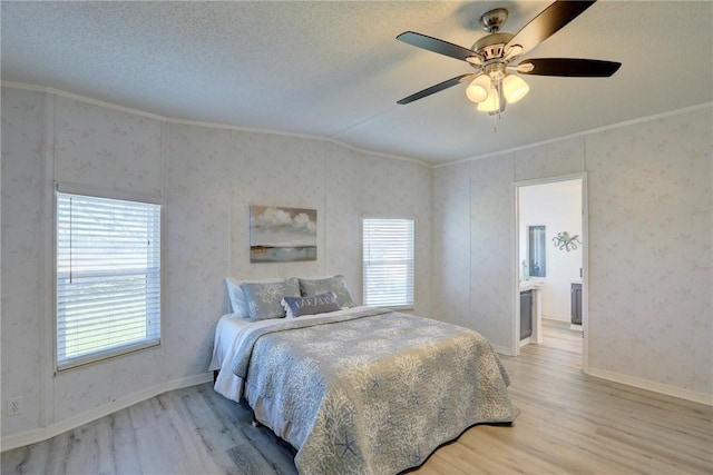 7519 Chasta Rd Unit 0, Micco, FL 32976 - bedroom with light wood-style flooring, ornamental molding, baseboards, ceiling fan, and ensuite bath