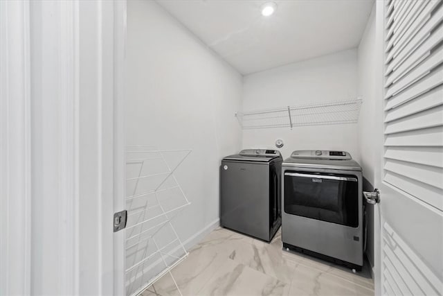 clothes washing area featuring independent washer and dryer