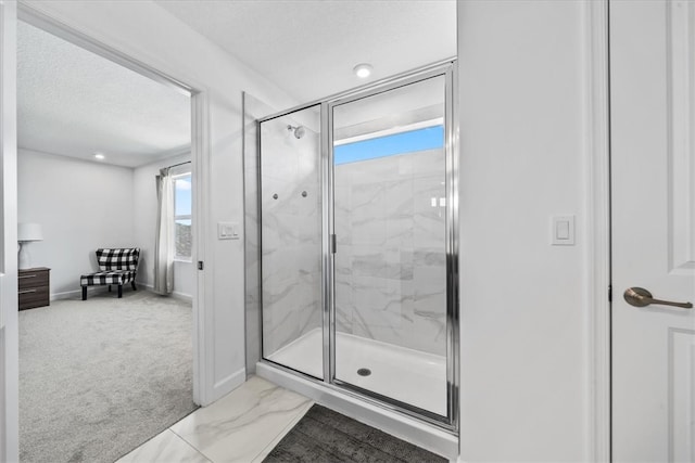 bathroom featuring walk in shower, a healthy amount of sunlight, and a textured ceiling