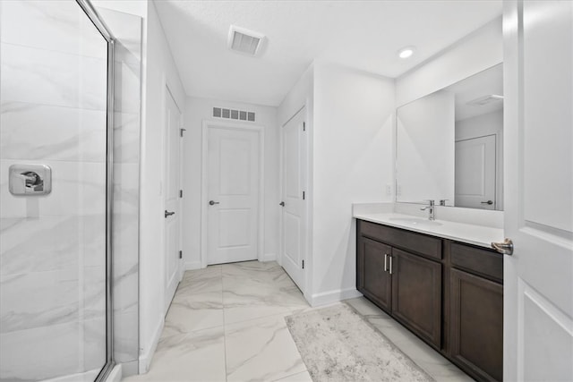 bathroom featuring vanity and an enclosed shower