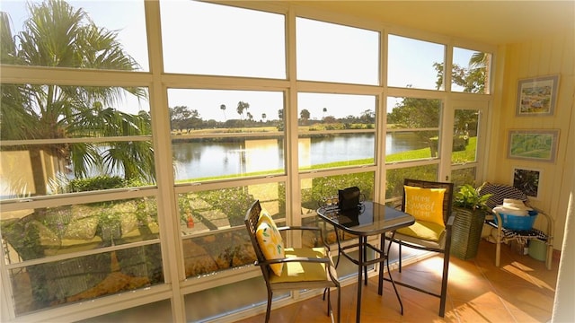 sunroom / solarium with plenty of natural light and a water view