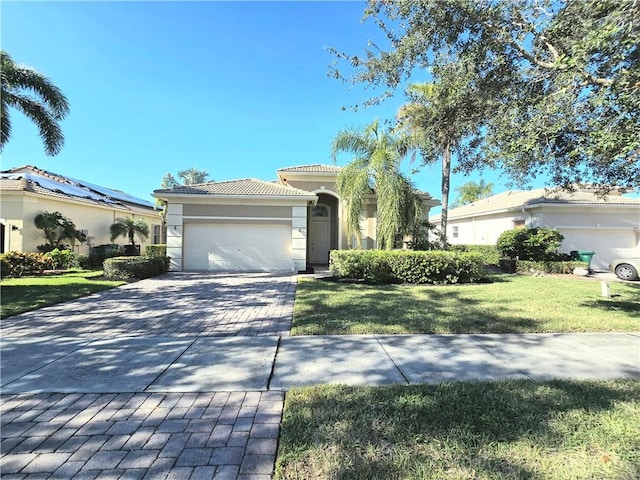 view of front of house with a garage and a front lawn