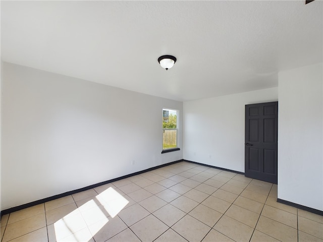 unfurnished room with light tile patterned floors