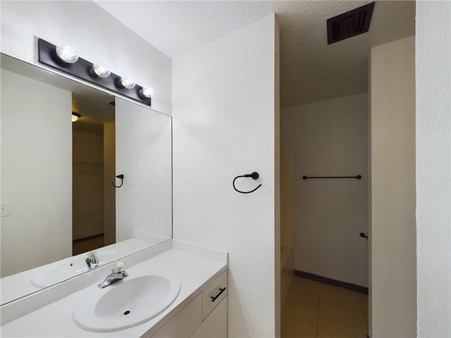 bathroom with tile patterned floors, vanity, and a bathtub