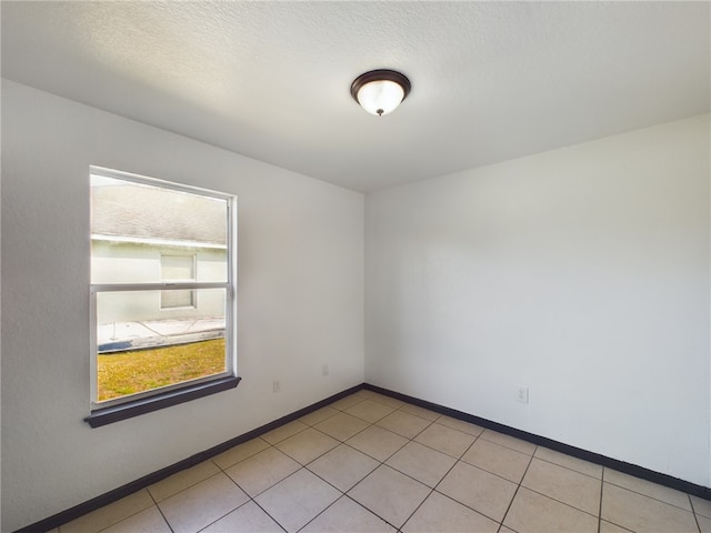 unfurnished room with a textured ceiling