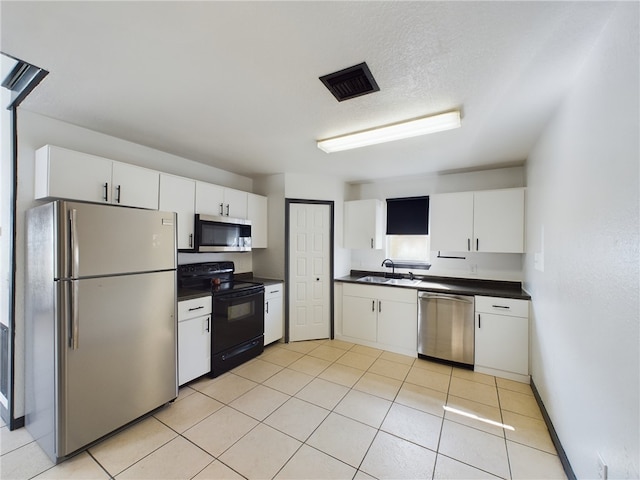 kitchen with white cabinetry, appliances with stainless steel finishes, sink, and a textured ceiling